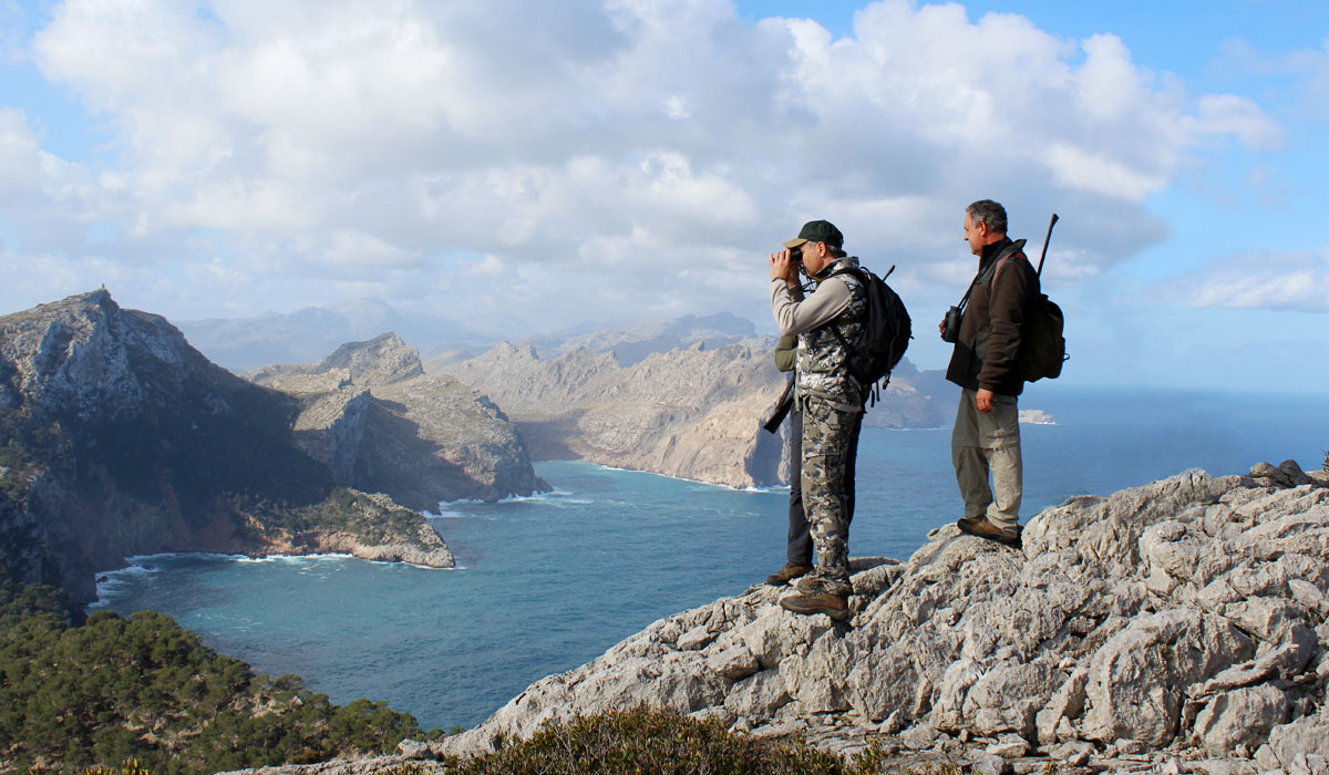 Three hunters with nice landscapes in the background when hunting the Balearean Boc in Mallorca, hunting in Mallorca, Spain