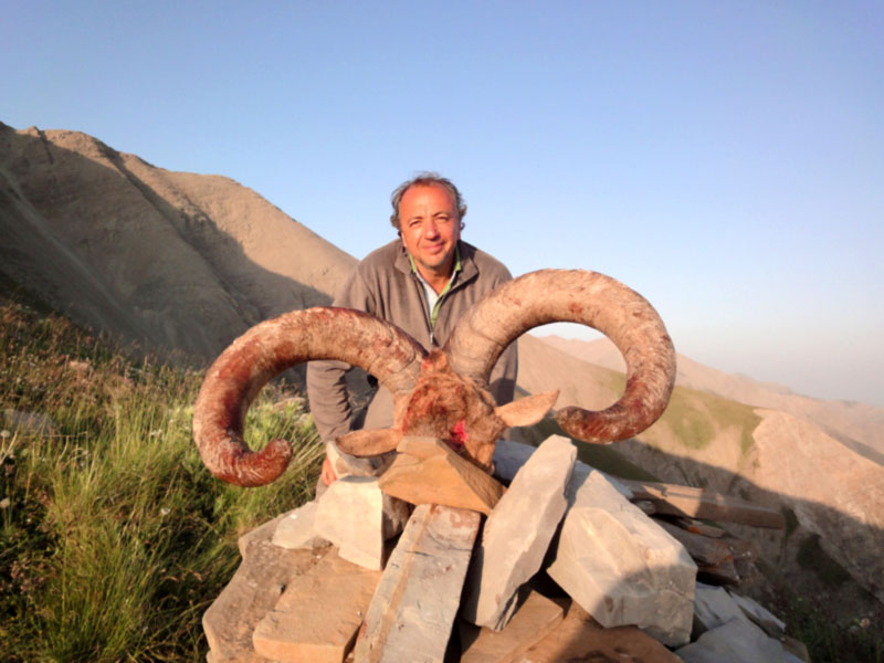 Hunter with a huge dagestan tur trophy, hunting in Russia
