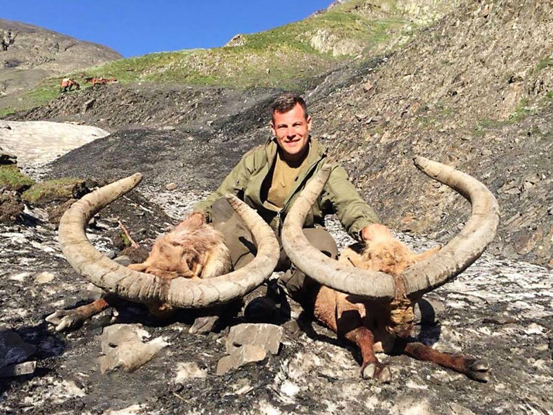 Hunter with two big dagestan tur trophies, hunting in Russia