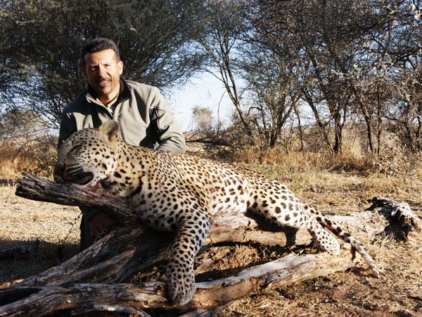 Hunter with a leopard trophy, hunting in Zimbabwe